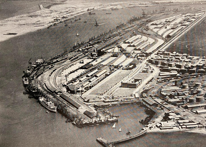 A black and white aerial photograph of Karachi port taken in 1929 showing the East Wharf, Keamari Yard, and oil terminals in the foreground and the newly constructed West Wharf in the background.&nbsp;