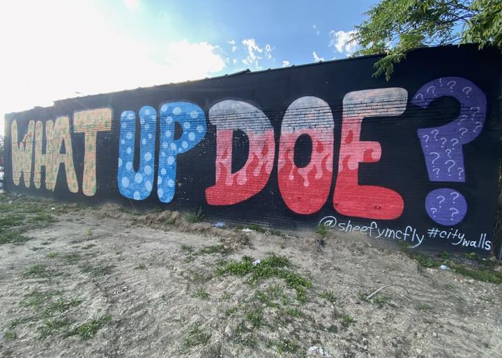 Alt Text:  Graffiti on a wall saying 