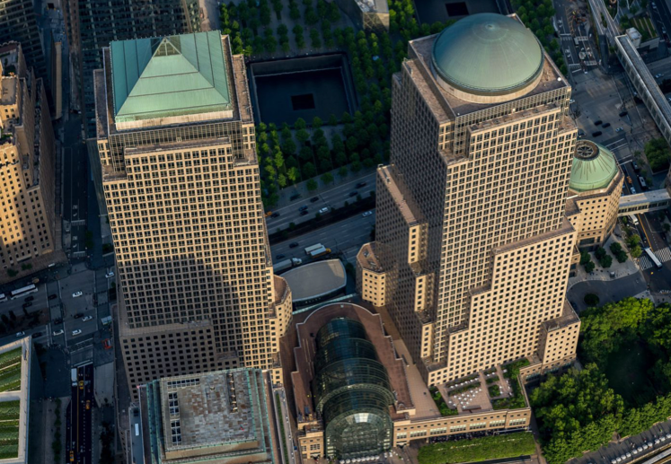 Areal view of two buildings with turquoise-colored roofs.